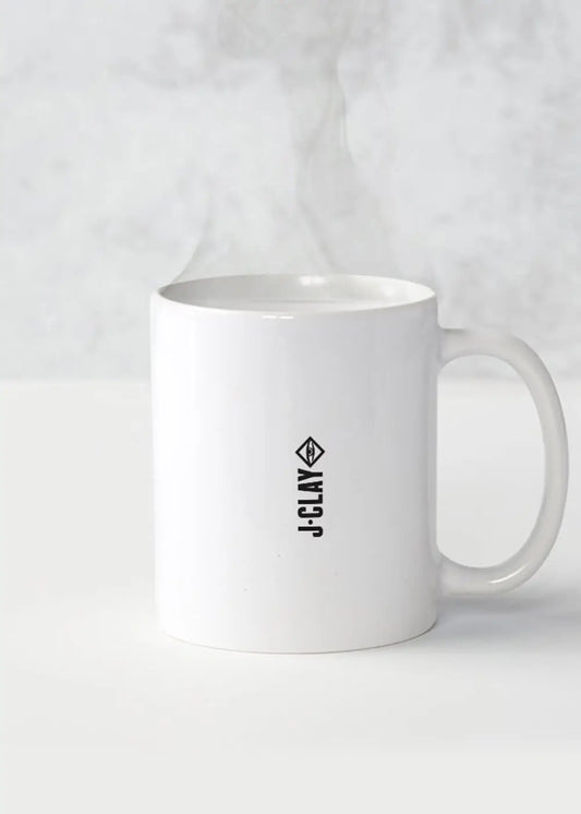 Weiße Kaffeetasse mit Dampf und kleinem vertikalen J.Clay Logo, Bier Brot Butter Edition.
