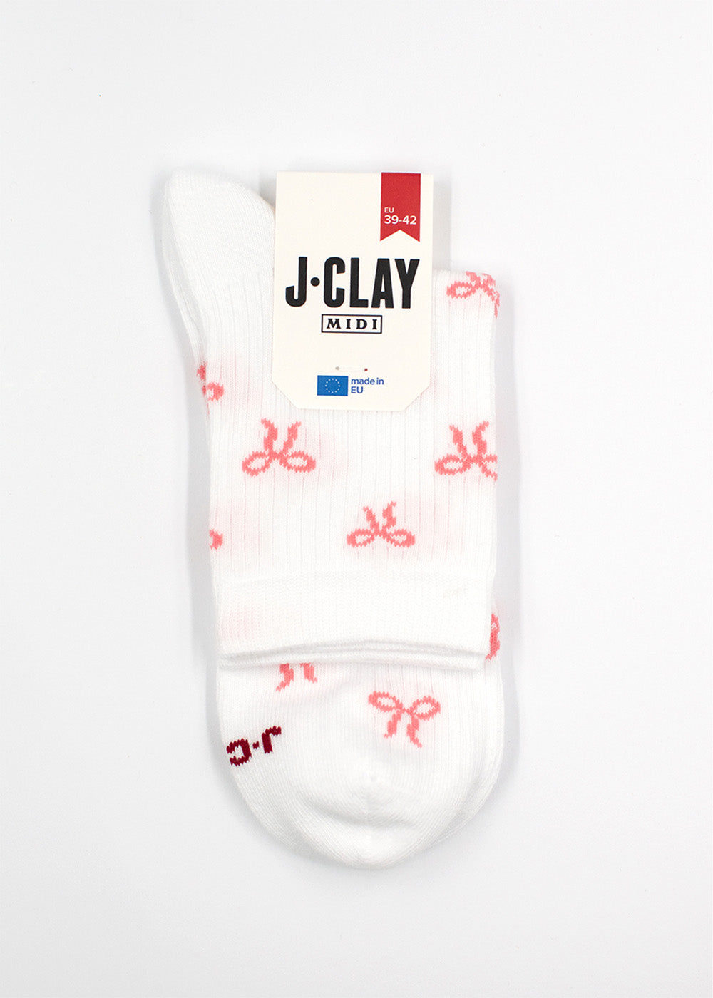 Bowtiful - Weiße Midi-Socken mit rosa Schleifen, gefaltet mit einem J.Clay-Etikett oben drauf.