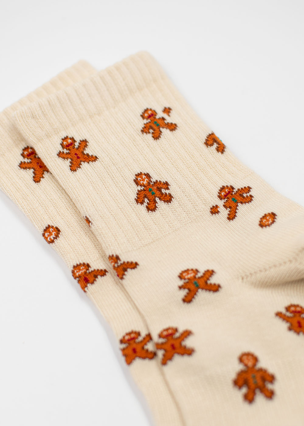 Cremefarbene J.Clay-Lebkuchenmann-Kindersocken mit einem sich wiederholenden Lebkuchenmann-Muster.