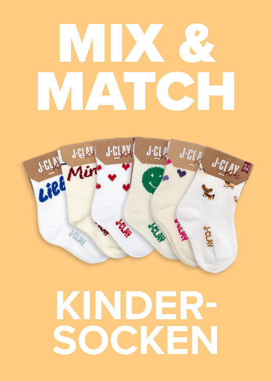 Sechs Paar J.Clay MIX  MATCH Kinder-Socken mit verschiedenen Motiven auf pfirsichfarbenem Hintergrund.