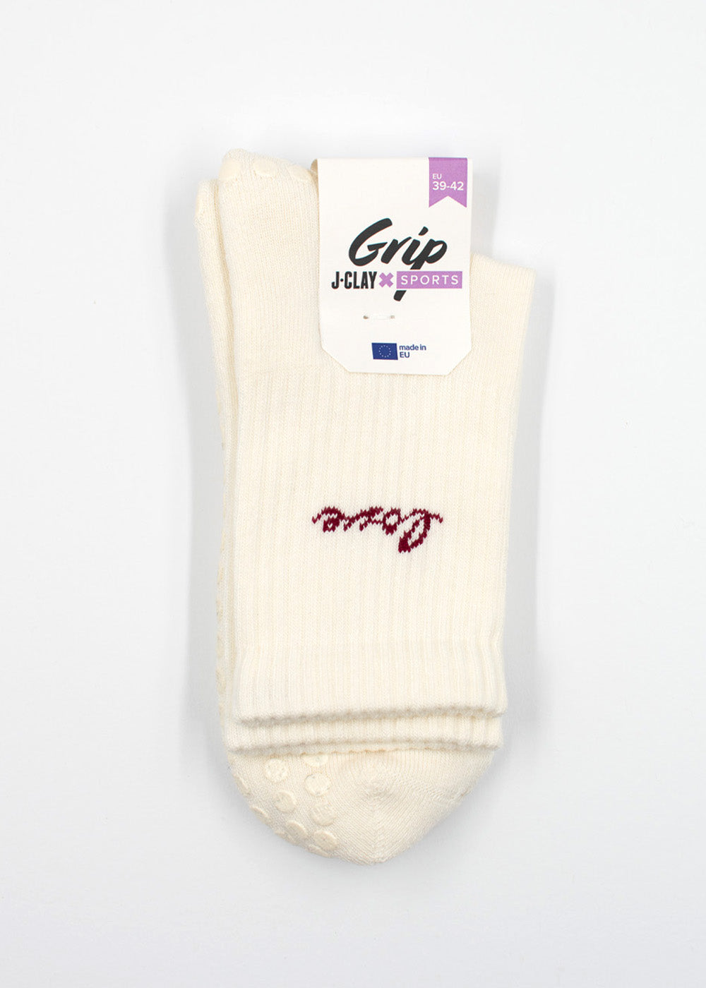 Ein Paar weiße Love Grip Socken von J.Clay mit rotem Schriftzug oben drauf.