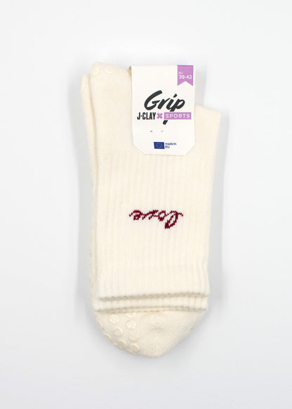 Ein Paar weiße Love Grip Socken von J.Clay mit rotem Schriftzug oben drauf.