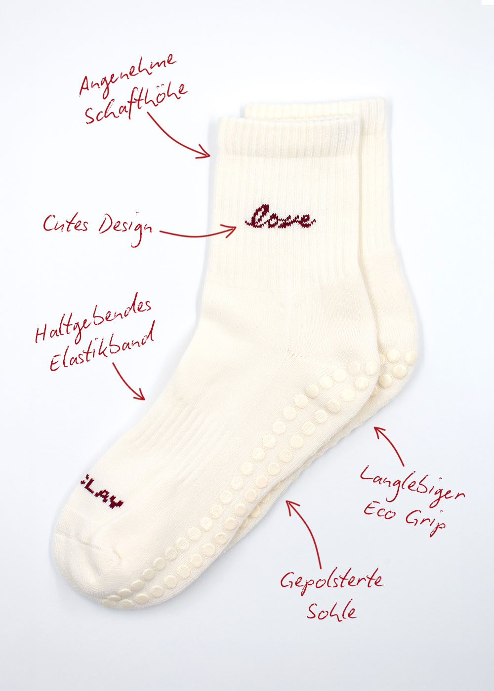 Zwei weiße J.Clay Love Grip Socken mit rotem Text, Pfeilen und hervorgehobenen deutschen Merkmalen.