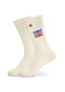 Weiße Merde Merde Tennissocken von J.Clay mit blau-rotem MERDE-Schriftzug.