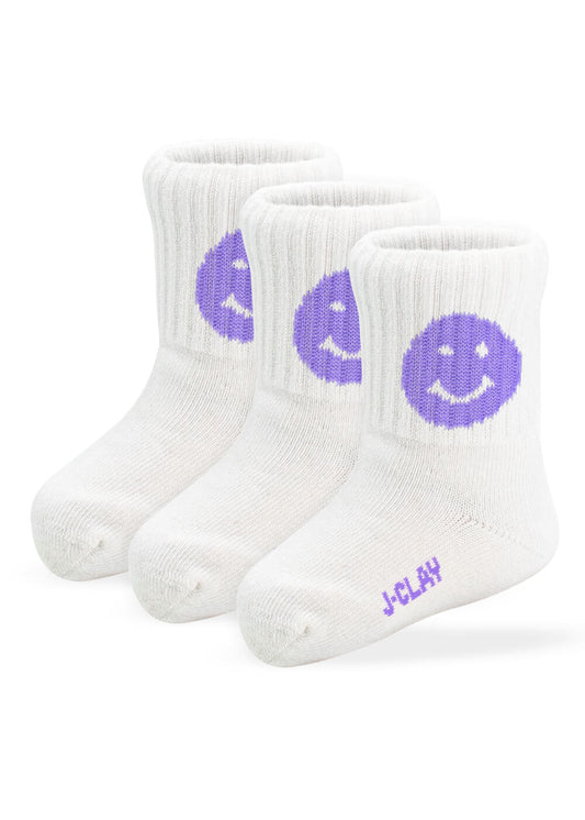 Drei Paar weiße gerippte Babysocken von J.Clay, jeweils mit einem lila Smiley am Knöchel und "J-Clay" in Lila an der Spitze. Diese stylischen Socken sind perfekt für Kinder im Alter von 0-4 Jahren und bringen Spaß an die kleinen Füße!.