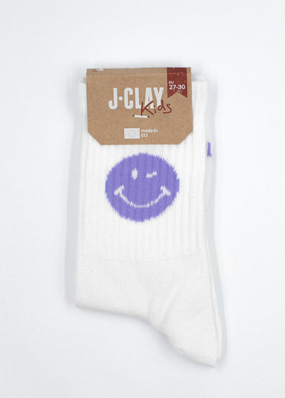 White Purple Smile - Kindersocken mit lilafarbenem Smiley-Gesicht und J.Clay-Etikett.