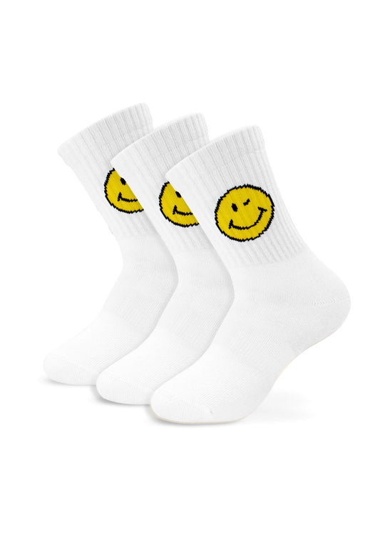 Drei Paar weiße J.Clay Kinder Tennissocken, jedes mit einer großen gelben Smiley-Grafik am oberen Rand. Aufrecht und leicht angewinkelt positioniert, sind sie perfekt als Kindersocken ab 5 Jahren mit Gesichtern deutlich sichtbar.
