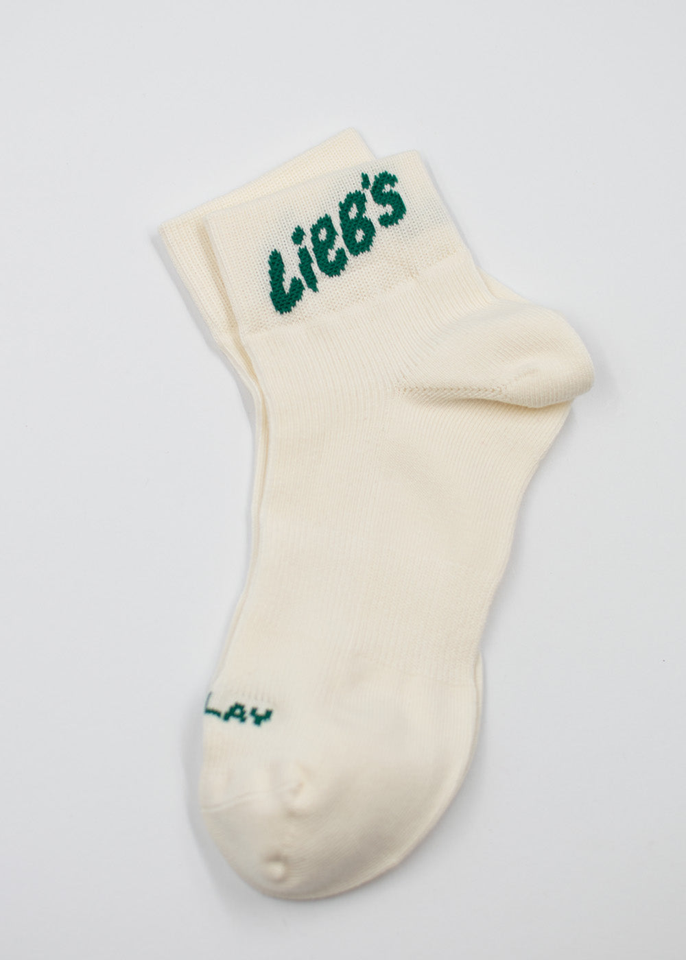 J.Clay Lieb’s Sneaker-Socken High: cremefarben, Baumwolle, grüner „Liebs“-Schriftzug, Made in Germany.