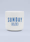 Eine weiße J.Clay Tasse ohne Henkel aus Keramik mit blauem SUNDAY CLUB-Schriftzug auf der Vorderseite und hellblauem Hintergrund - ein ideales Geschenk und eine stilvolle Ergänzung für jedes Geschenkset.