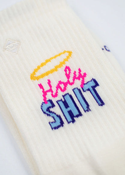Off-white Holy Shit – Weihnachtssocken mit einem gelben Heiligenschein über rosa und blauem Schriftzug.