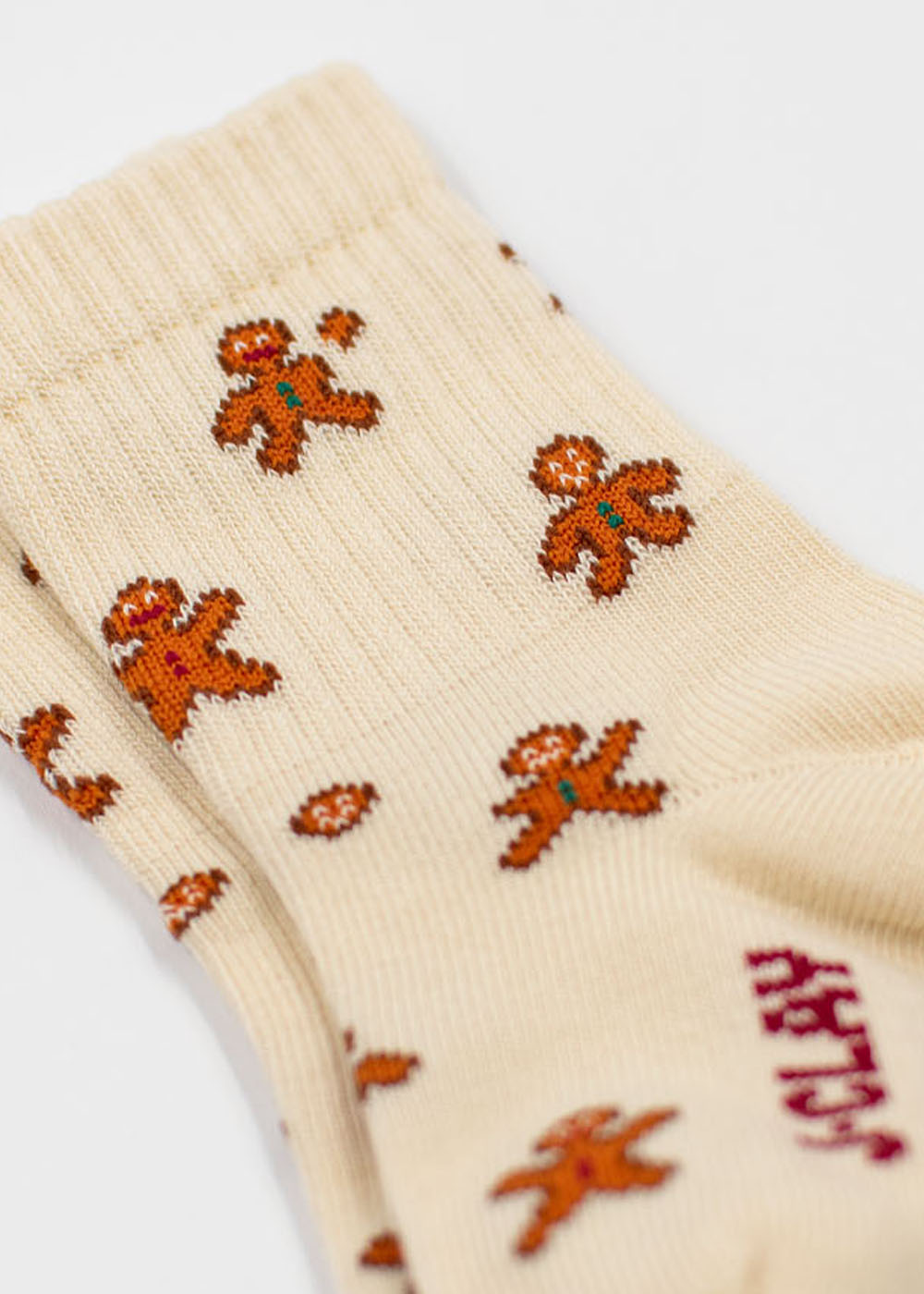 Cremefarbene Lebkuchenmann-Socken im Familienpack mit Lebkuchenmann-Motiv.