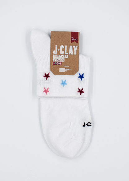 White Stars – SSH-Socken von J.Clay, mit farbigen Sternen, braunem Etikett und der Aufschrift „J.C.“ an der Zehenpartie.